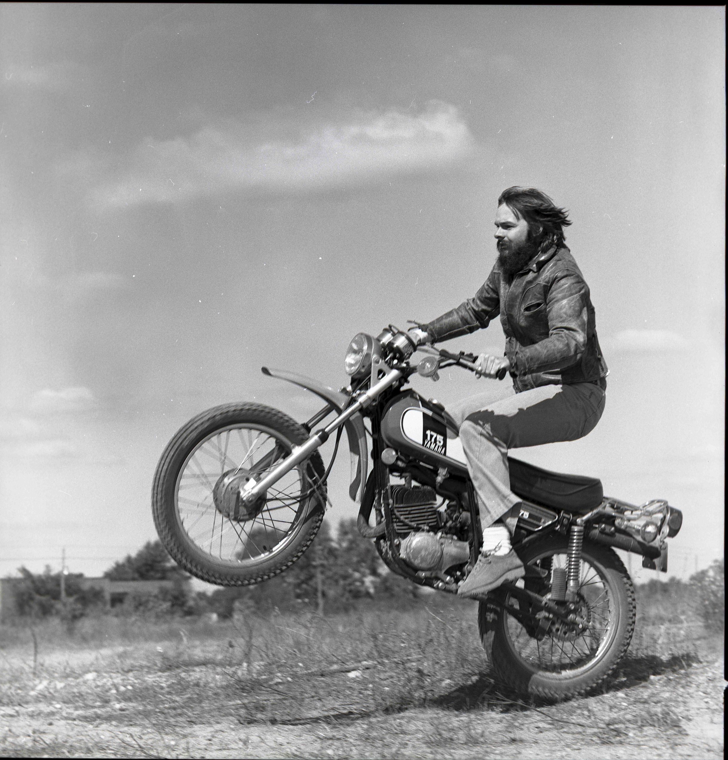 Rich Gootee of Good Seed Band riding a motorcycle in the 1970s